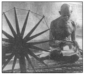 [Image of Gandhi at Spinning Wheel]